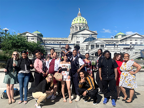 Youth advocates standing outside PA's capitol building.