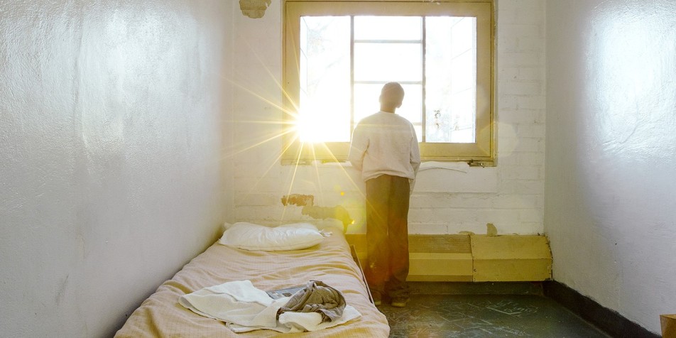 child in a detention center cell