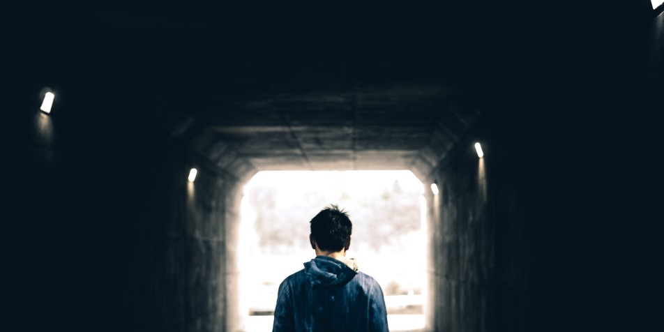 Silhouette of teenager in a tunnel