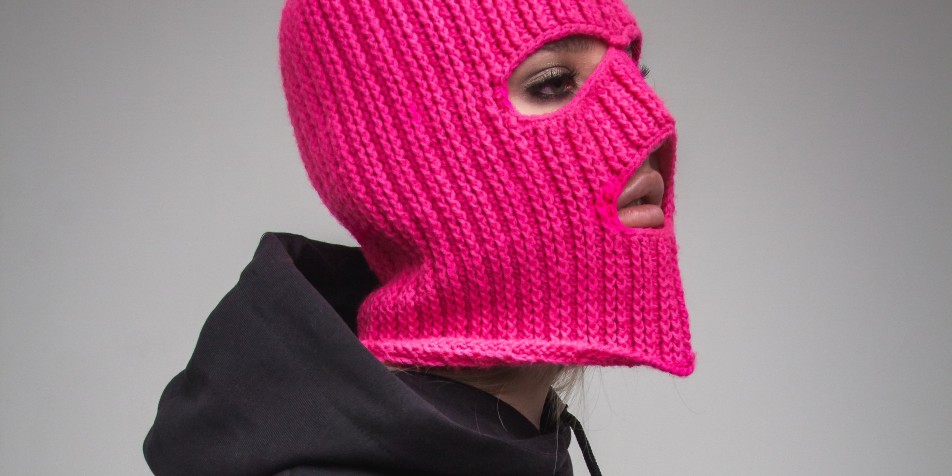 person in pink ski mask and black hoodie